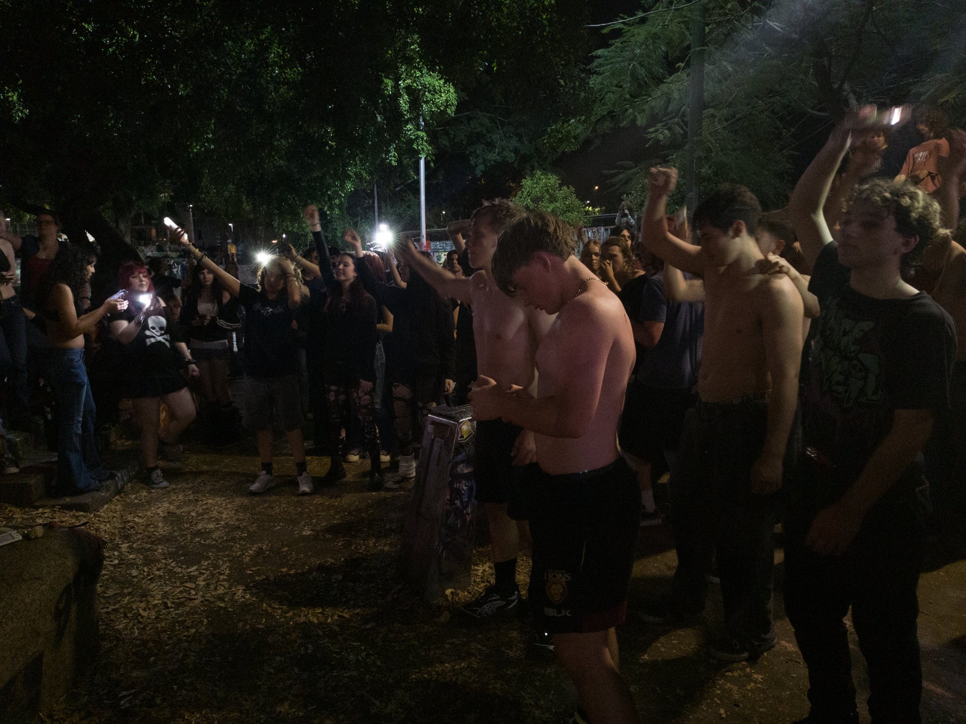 A packed all-ages crowd pressed to the front of a small gig